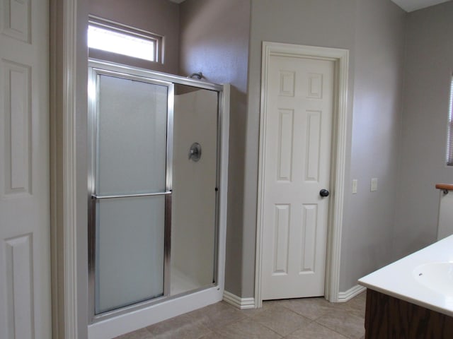 bathroom with tile patterned flooring, vanity, and an enclosed shower