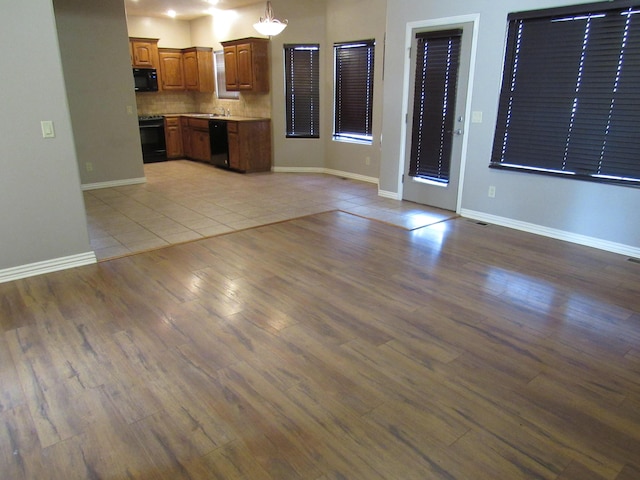 unfurnished living room with light tile patterned floors and sink