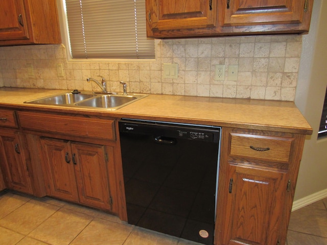 kitchen featuring backsplash, light tile patterned flooring, sink, and black dishwasher