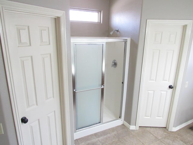 bathroom with tile patterned floors and an enclosed shower