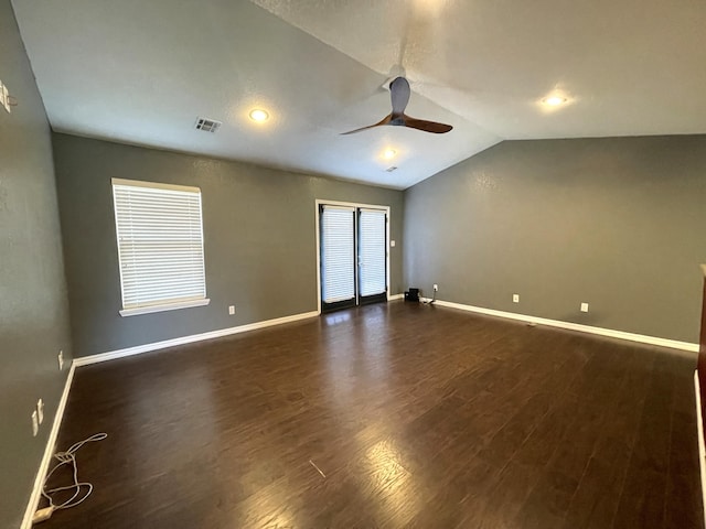 spare room featuring ceiling fan, dark wood-type flooring, and lofted ceiling