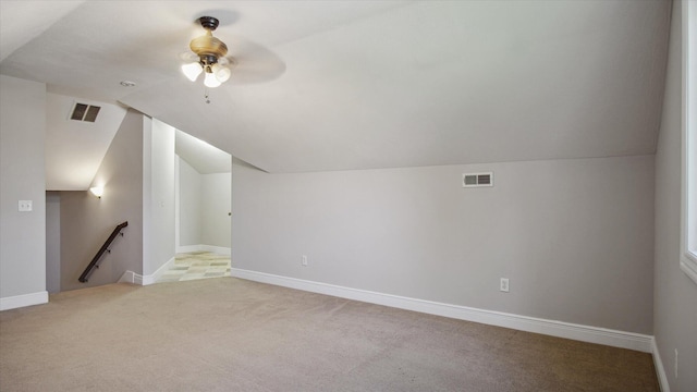 additional living space with light carpet, vaulted ceiling, and ceiling fan