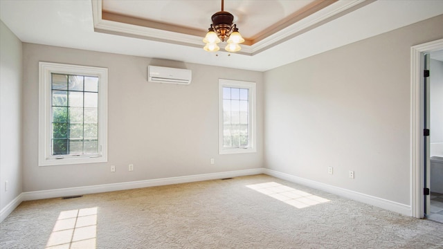 carpeted empty room featuring a tray ceiling, ceiling fan, plenty of natural light, and a wall mounted air conditioner