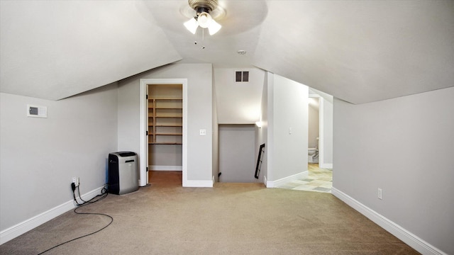 additional living space with ceiling fan, lofted ceiling, and light carpet