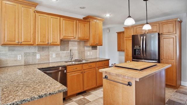 kitchen featuring pendant lighting, sink, tasteful backsplash, a kitchen island, and stainless steel appliances