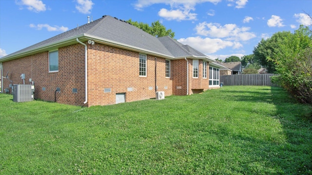 view of home's exterior featuring central air condition unit and a lawn