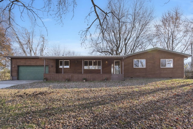 ranch-style home with covered porch and a garage