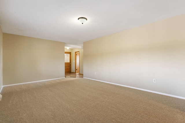 empty room featuring light carpet