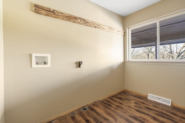 laundry area with dark hardwood / wood-style floors and hookup for a washing machine