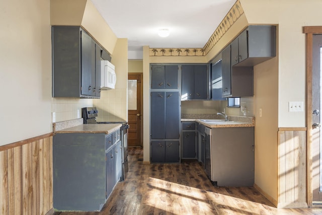 kitchen with dark hardwood / wood-style flooring, black range with electric cooktop, gray cabinetry, and sink