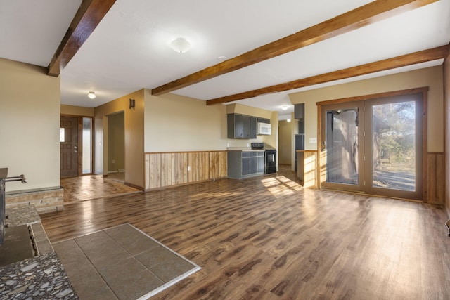 unfurnished living room featuring beamed ceiling and dark wood-type flooring