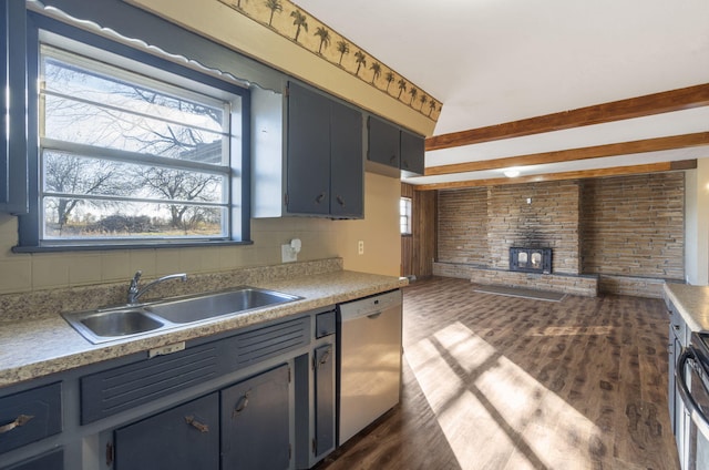 kitchen with a wood stove, sink, stainless steel dishwasher, tasteful backsplash, and dark hardwood / wood-style flooring