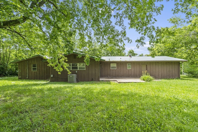 1350 S 20th St, Ozark, MO 65721 - back of property with a lawn, board and batten siding, and central AC unit