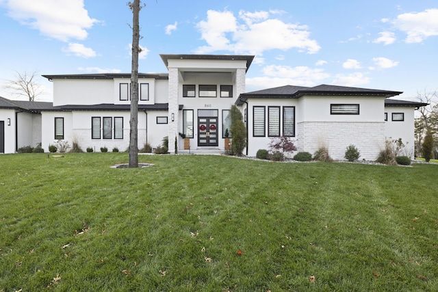 view of front of house featuring a front yard and french doors