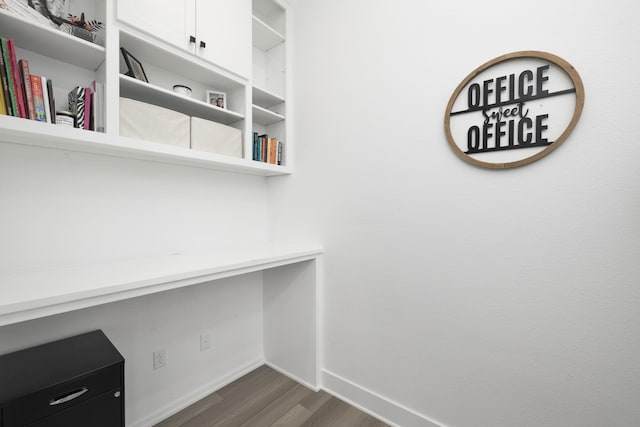 unfurnished office featuring dark wood-type flooring