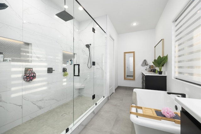 bathroom with vanity and a shower with door