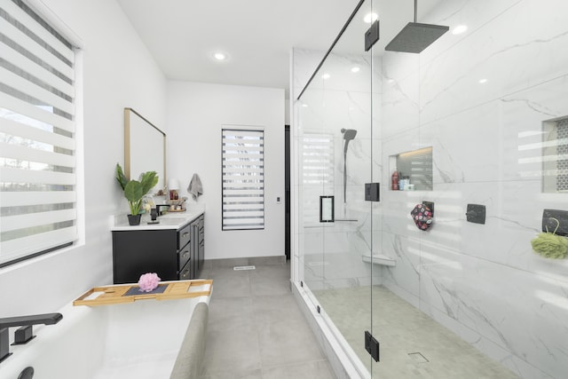 bathroom with vanity and separate shower and tub