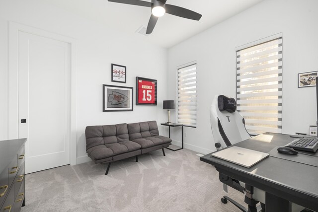 home office with ceiling fan and light carpet