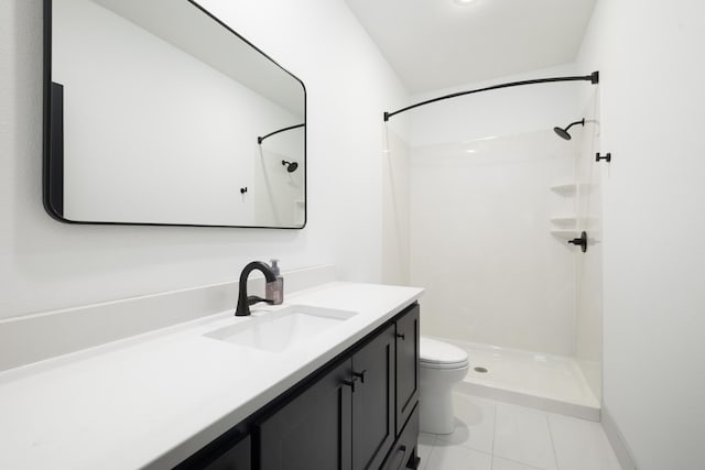 bathroom featuring tile patterned floors, toilet, vanity, and walk in shower