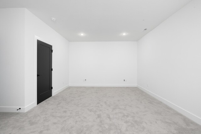 unfurnished room with light colored carpet