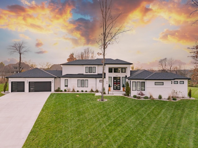 prairie-style home featuring a yard and a garage