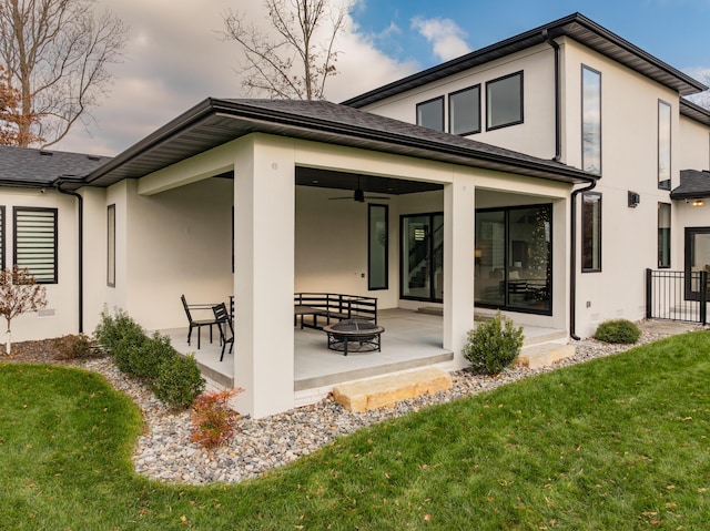 rear view of property with a yard, a patio, and ceiling fan