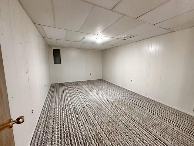 basement featuring a drop ceiling and carpet floors