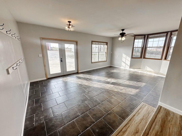 spare room featuring ceiling fan, dark hardwood / wood-style floors, and french doors