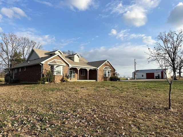 view of front of home with a front lawn and cooling unit