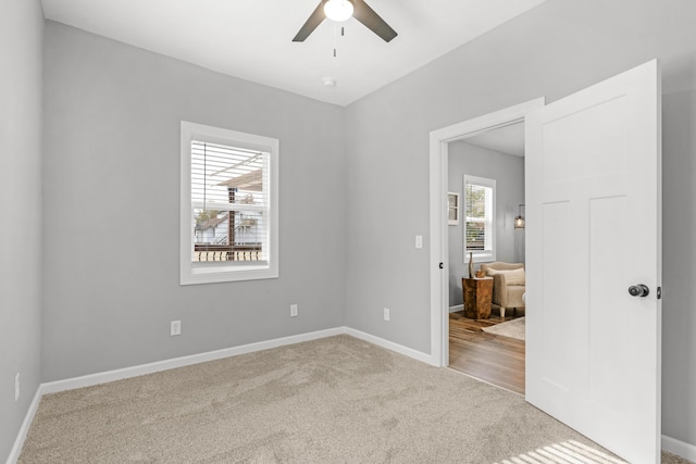 empty room with carpet and ceiling fan