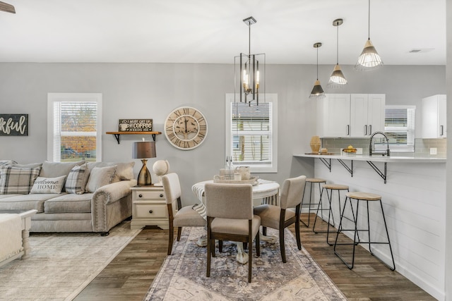 dining space with a chandelier and dark hardwood / wood-style floors