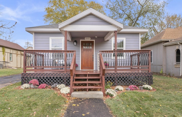 bungalow-style house with a front yard