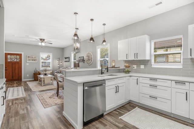 kitchen with white cabinets, dishwasher, ceiling fan, and kitchen peninsula