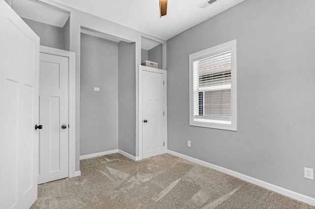 unfurnished bedroom featuring ceiling fan, light carpet, and a closet