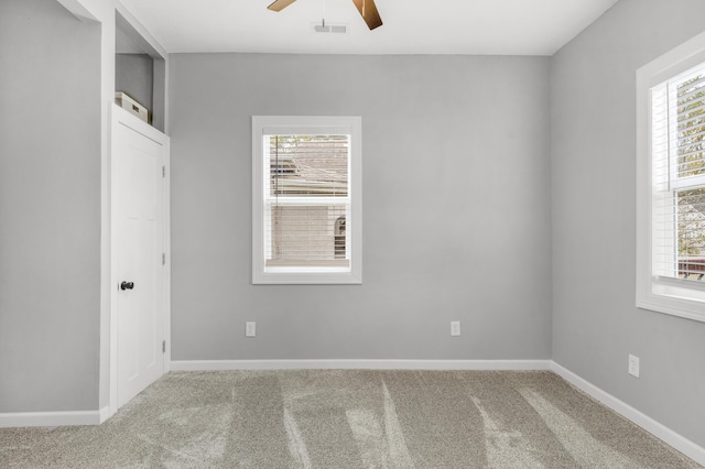 empty room featuring carpet and ceiling fan