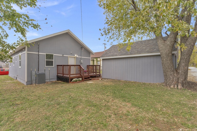 rear view of property with a lawn and a deck