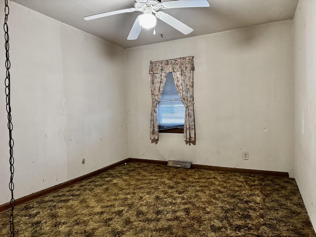 spare room featuring ceiling fan and carpet