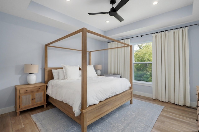 bedroom with ceiling fan and light hardwood / wood-style floors