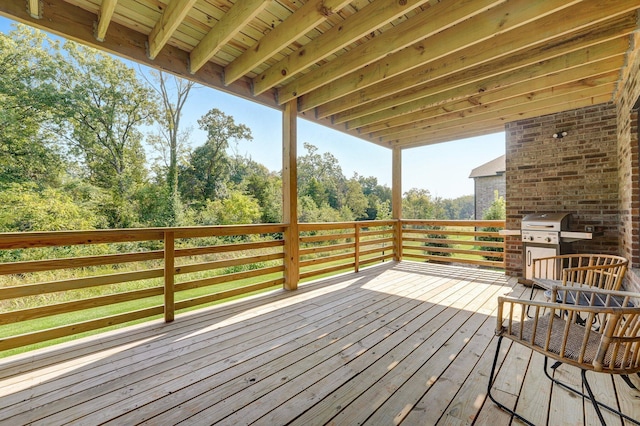 wooden terrace featuring grilling area