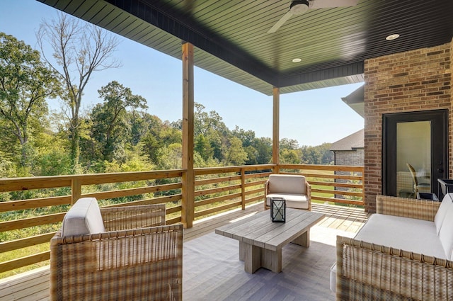 wooden deck featuring ceiling fan