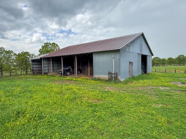 view of pole building with fence and a carport