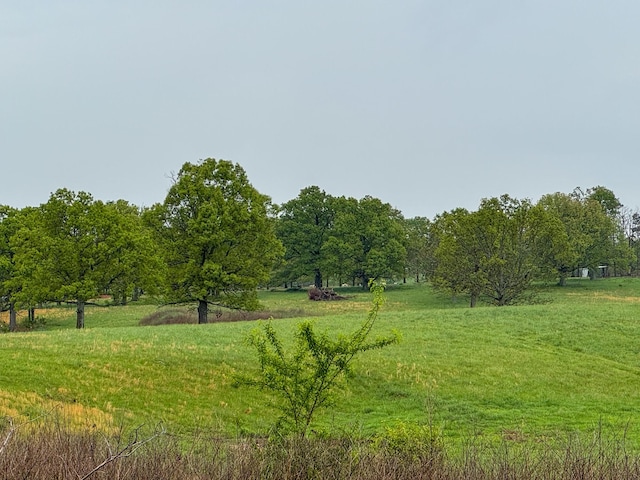 view of home's community featuring a rural view and a lawn