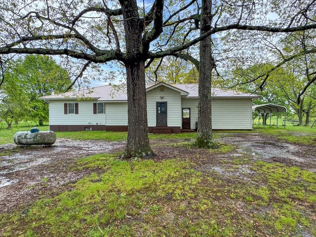 view of front of property with metal roof, a detached carport, and entry steps