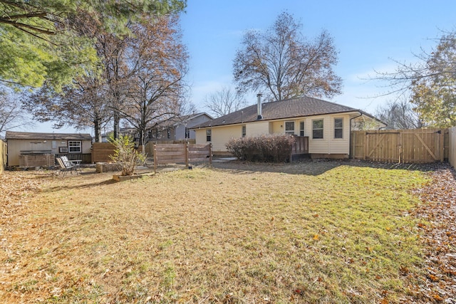 back of house featuring a deck and a lawn