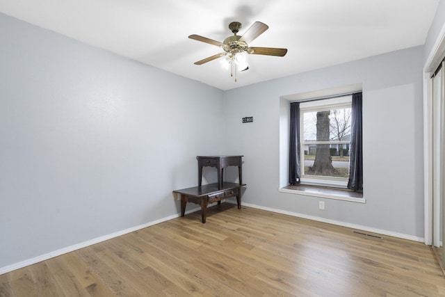 spare room with ceiling fan and light hardwood / wood-style floors