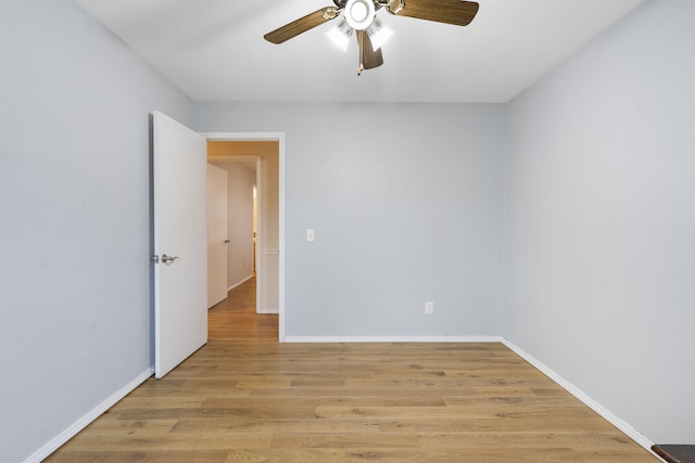 spare room featuring light hardwood / wood-style flooring and ceiling fan