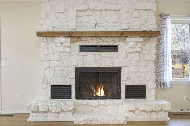 details featuring hardwood / wood-style flooring and a fireplace