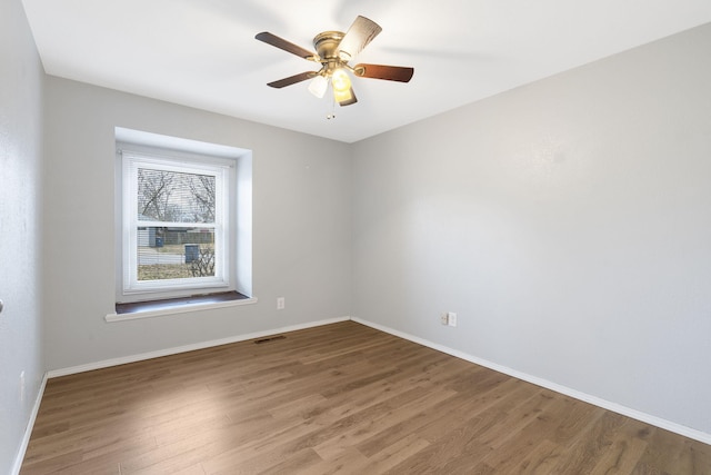 empty room featuring hardwood / wood-style floors and ceiling fan