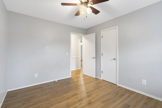 unfurnished bedroom featuring hardwood / wood-style flooring and ceiling fan