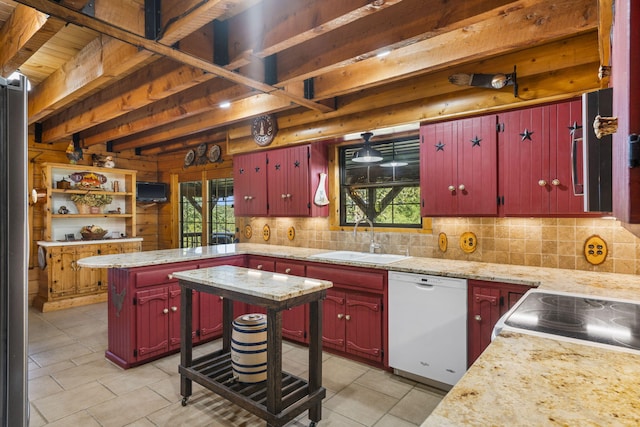 kitchen featuring beamed ceiling, dishwasher, sink, decorative backsplash, and a healthy amount of sunlight